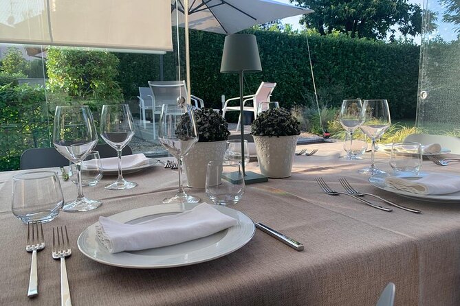 3 Hours Pizza and Tiramisù Workshop in Como - The meal setting: eating what you made in a glass-enclosed dining room